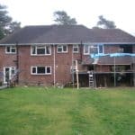 House extension under construction with scaffolding and building materials.