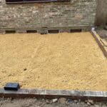 Extension foundation preparation for rear home renovation project.
