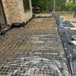 Construction site for rear extension with rebar reinforcement in Wrecclesham.