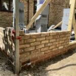Extension construction site in Wrecclesham showing brickwork and scaffolding.