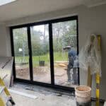 Rear extension construction with large sliding glass doors in Wrecclesham.