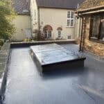 Extension roof with flat roofing system in Wrecclesham.