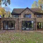 Modern brick rear extension with large glass doors and windows, enhancing natural light and outdoor.