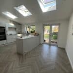 Bright and spacious kitchen in a rear extension with skylights and large glass doors for natural lig.