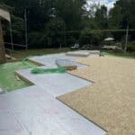 Insulation installation on a building roof with reflective foil and OSB boards for thermal efficienc.
