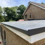 Flat roof construction with durable waterproofing and modern materials for residential extension. Ex.