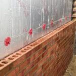 Brick wall construction for rear extension in Tongham.