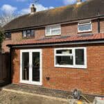 Rear extension with double doors and large window in Tongham.