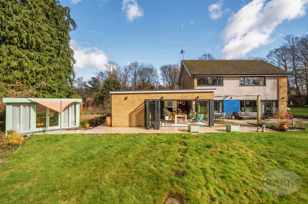 Contemporary home extension showcasing innovative design and quality construction in a lush garden s.