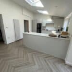 Rear extension with modern white kitchen and skylights for natural light.