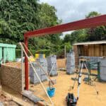 Modern extension construction with brickwork and structural elements.