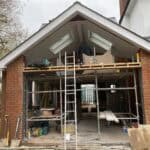 Rear extension building in progress at Winchfield, showcasing brickwork and roofing installation.