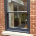 Rear extension window with black frame in a brick wall, enhancing natural light and aesthetic appeal.