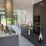 Modern kitchen with sleek cabinetry and large windows in Winchfield.