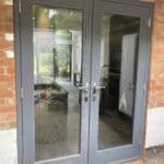 Modern grey double-glazed rear door for extension.