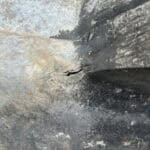 Close-up of damaged wall surface during extension and refurbishment work in Normandy.