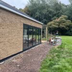 Extension with large glass sliding doors for natural light and outdoor access.