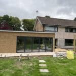 Modern house extension with large glass windows in Normandy.