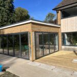 Bright, spacious glass extension with large sliding doors for seamless indoor-outdoor living.