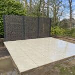 Modern porcelain patio with decorative privacy screen in Wrecclesham.