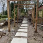 Porcelain patio pathway with wooden frames in Wrecclesham, showcasing modern outdoor landscaping.