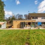 Outdoor garden extension with patio and seating area, showcasing contemporary design and landscaping.