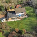 Residential home with landscaped garden and outdoor living space.