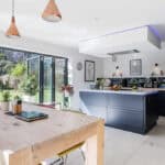 Bright, spacious kitchen and dining room with large windows, modern decor, and a view of the garden.