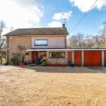 Contemporary two-storey house with attached garage and spacious driveway.