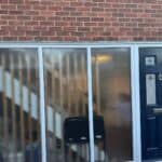 The old side entrance with large glazed panels, before the work