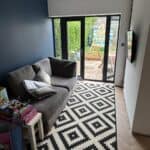 Finished living space in the converted garage with glazed doors to the garden