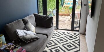Finished living space in the converted garage with glazed doors to the garden