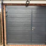 The original garage door kept on the extended garage for a storage area
