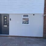 New front door and window with a rendered finish