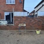 Wraparound extension and kitchen refit in Aldershot – brickwork going up in brick chosen to match the house