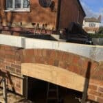 Wraparound extension and kitchen refit in Aldershot – new opening with a brick arch being formed