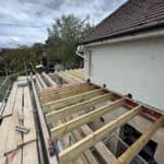 Wraparound extension and garage conversion in Farnham – flat roof joists going on over the extension
