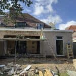 Wraparound extension and garage conversion in Farnham – the extension shell complete, ready for windows and render