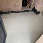 Wraparound extension and garage conversion in Farnham – liquid screed floor going down