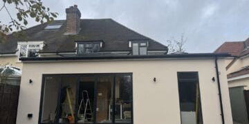 Wraparound extension and garage conversion in Farnham – finished rear: bifold doors and through-coloured render