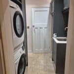 Wraparound extension and garage conversion in Farnham – utility room with stacked washer and dryer