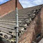 The old roof stripped back from the derelict side extension