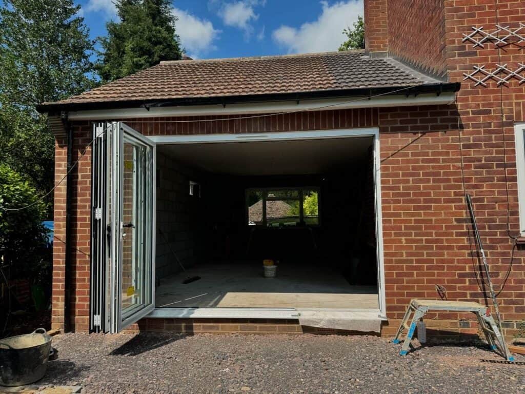 Rebuilt side extension with bifold doors open, Fleet