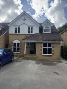 Finished garage conversion with a new front window and matched brickwork