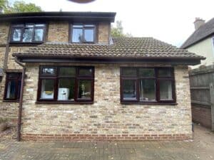 Garage doors replaced with two windows and brickwork matched to the house